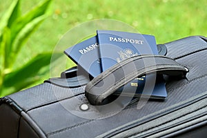 Two US passports on suitcase