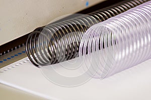 Two useful plastic binding combs white and black on a Binding machine