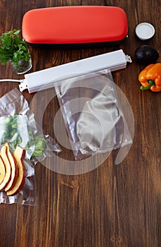 Two vacuum cleaners for food on a wooden table