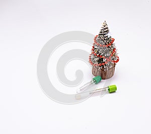 Two vacuum tubes for collection blood samples witn christmas three on white background