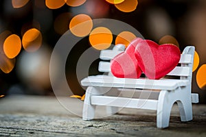 two valentine hearts on a wooden bench