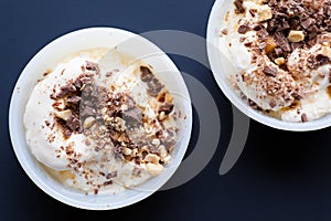 Two vanilla ice-cream with chocolate. Selective focuse