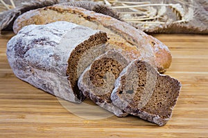 Two varities of brown bread on wooden surface close-up