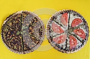 Two vegetarian pies with vegetables and vegan nutrients. Food on yellow background