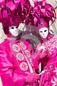 Two Venetians in pink costumes photo