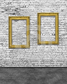 Two vertical golden frames on brick wall