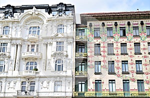 Two very different historical buildings side by side, in Vienna, different style facades but both beautiful.