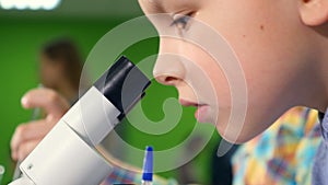 Two very enthusiastic school boys doing science experiment in school laboratory. Close up.