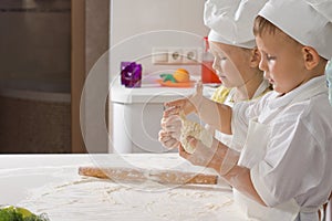 Two Very Young Chefs Preparing for Pizza