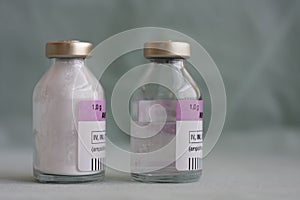 Two vials of antibiotics, in the one is powder, in the second is diluted  solution.,  injection drugs used in treatment of