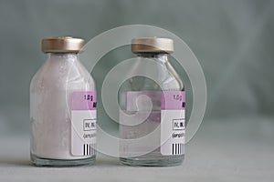 Two vials of antibiotics, in the one is powder, in the second is diluted  solution.,  injection drugs used in treatment of photo