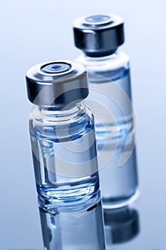 Two vials of water sitting on top of a table