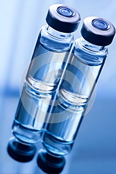 Two vials of water sitting on top of a table