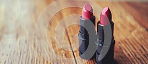 Two Red Lipsticks on Wooden Table