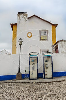 Two Vintage Blue Phone Call Boxes, an Old Lamp, an House and Cob