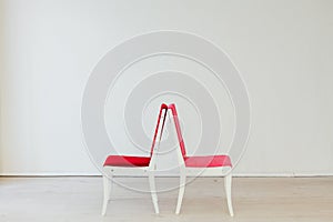 Two vintage chairs in the interior of an empty white room