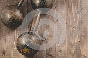 Two vintage dumbbells/Two vintage dumbbells on the black wooden