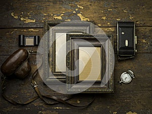 Two vintage frames over a wood background