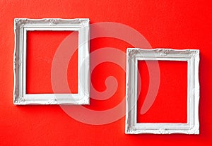 Two vintage frames on red wall