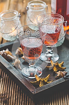 Two vintage glasses of red wine with bottle and lantern