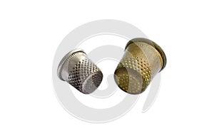 Two vintage thimbles isolated on a white background