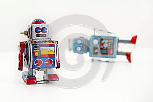 Two vintage tin toy robots isolated on white background