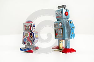 Two vintage tin toy robots isolated on white background