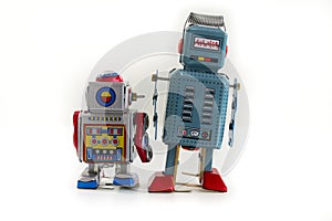 Two vintage tin toy robots isolated on white background