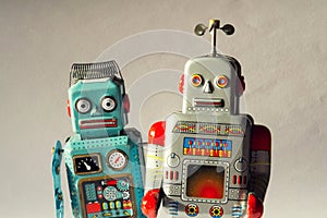 Two vintage tin toy robots, robotic delivery, artificial intelligence concept