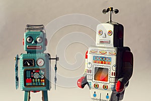 Two vintage tin toy robots, robotic delivery, artificial intelligence concept