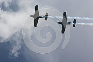 Two Vintage War Planes Fly Overhead Trailing Smoke