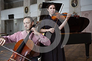 Two violinists performing together hands close up