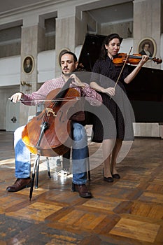 Two violinists performing together hands close up