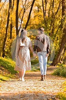 Two walking lovers having romantic date at forest