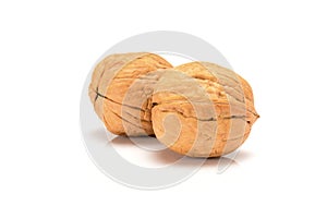 Two walnuts, close up macro, isolated on a white background.