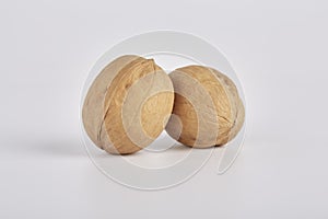 Two walnuts on a light background close-up
