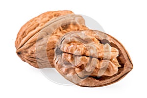 Two Walnuts whole and half in closeup.