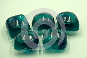 Two washing gel capsule pods with laundry detergent isolated on white background with clipping path .