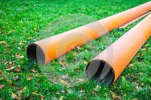 Two water pipes on grass during plumbing repairs under construction