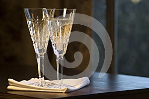 Two Waterford Champagne Glasses on Wooden Table