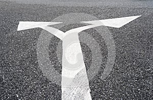 Two way arrows symbol on asphalt road