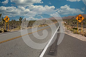 Two-way traffic ahead sign on an empty highway through the Arizona