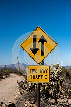 Two Way Traffic Sign Along Desert Dirt Road