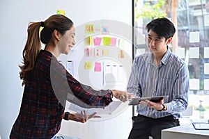 Two web developer are planning sketch, prototype, framework, layout app design project together.