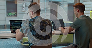 Two Web developers working at the computer inthe modern office.