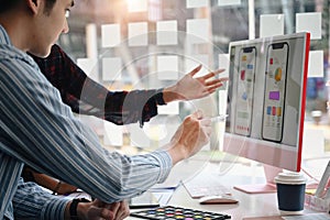 Two web developers  working together for mobile application software design project.