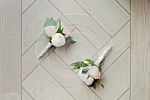 Two wedding buttonhole made of white roses