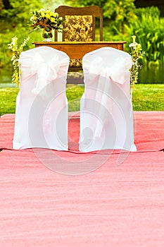 Two wedding chairs with white elegant covers