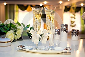 Two wedding champagne glass on table in beatiful decorated restaraunt
