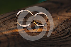 Two wedding engagement rings on a wooden base For a gold ring of a loving wedding couple.Concept of love